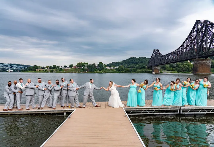 Wedding party on a riverside dock